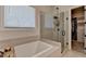 Luxurious bathroom featuring a walk-in shower, a soaking tub, and a walk-in closet at 3003 Evanshire Ave, Duluth, GA 30096