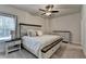 Bedroom featuring neutral paint, carpeted floor, large windows, ceiling fan, and a bed at 3003 Evanshire Ave, Duluth, GA 30096