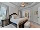 Elegant bedroom with tray ceiling, a large bed and an ensuite bathroom entrance at 3003 Evanshire Ave, Duluth, GA 30096