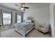 Bedroom featuring neutral paint, carpeted floor, large windows, ceiling fan, and a bed at 3003 Evanshire Ave, Duluth, GA 30096