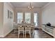 Bright dining area features a white table set, stylish chandelier, and natural light from nearby windows at 3003 Evanshire Ave, Duluth, GA 30096