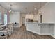 Open dining area with a view of the modern kitchen, offering a seamless transition for dining and entertaining at 3003 Evanshire Ave, Duluth, GA 30096