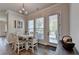 Bright dining area with white table set, stylish chandelier, and easy access to outdoor patio through glass door at 3003 Evanshire Ave, Duluth, GA 30096