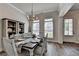 Bright dining room featuring a farmhouse table, chandelier, and built-in shelving for elegant and comfortable dining at 3003 Evanshire Ave, Duluth, GA 30096