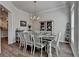 Charming dining room area featuring wood floors, stylish furnishings, and a view of the kitchen at 3003 Evanshire Ave, Duluth, GA 30096