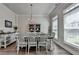The charming dining room area features wood floors, stylish furnishings, and plenty of natural light at 3003 Evanshire Ave, Duluth, GA 30096