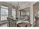 Open dining space showcases a modern chandelier and view into the adjacent living area, perfect for entertaining guests at 3003 Evanshire Ave, Duluth, GA 30096