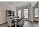 The charming dining room area features wood floors, stylish furnishings, and plenty of natural light at 3003 Evanshire Ave, Duluth, GA 30096