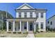 Charming two-story home featuring a welcoming front porch with elegant columns and a well-manicured lawn at 3003 Evanshire Ave, Duluth, GA 30096