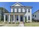 Charming two-story home featuring a welcoming front porch with elegant columns and a well-manicured lawn at 3003 Evanshire Ave, Duluth, GA 30096