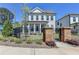 Beautiful home with a black metal fence surrounding a lush, green lawn and manicured landscaping at 3003 Evanshire Ave, Duluth, GA 30096
