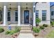 Inviting front porch with classic columns, brick steps, and charming details, creating a welcoming entrance at 3003 Evanshire Ave, Duluth, GA 30096