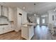 Open concept kitchen features stainless appliances, white cabinetry and modern pendant lighting at 3003 Evanshire Ave, Duluth, GA 30096