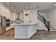 Spacious kitchen features stainless steel appliances, modern cabinetry and a beautiful island with pendant lights at 3003 Evanshire Ave, Duluth, GA 30096