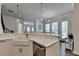 Open concept kitchen with white countertops and cabinets and stainless steel appliances at 3003 Evanshire Ave, Duluth, GA 30096