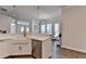 Kitchen with white cabinets, farmhouse sink, quartz countertops, and stainless steel dishwasher at 3003 Evanshire Ave, Duluth, GA 30096