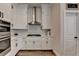 Modern kitchen featuring stainless steel appliances, white cabinets, and stylish range hood at 3003 Evanshire Ave, Duluth, GA 30096