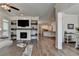 An open-concept home features wood floors, a fireplace, TV, and easy access to the kitchen at 3003 Evanshire Ave, Duluth, GA 30096