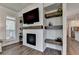 Comfortable living room featuring a modern fireplace, custom shelving, and ample natural light, creating a welcoming space at 3003 Evanshire Ave, Duluth, GA 30096