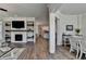 Open-concept living area with fireplace feature, integrated shelving, and seamless access to the adjacent kitchen and dining spaces at 3003 Evanshire Ave, Duluth, GA 30096