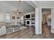 Inviting living room with a fireplace, decorative shelves, and access to the kitchen, perfect for relaxation and entertaining at 3003 Evanshire Ave, Duluth, GA 30096