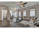 Inviting living room with hardwood floors, fan, and a comfortable sectional couch with plenty of natural light at 3003 Evanshire Ave, Duluth, GA 30096