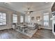 Bright living room with wood floors, lots of windows, and a comfortable sectional sofa at 3003 Evanshire Ave, Duluth, GA 30096