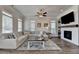 Bright living room with wood floors, lots of windows, fireplace, and a comfortable sectional sofa at 3003 Evanshire Ave, Duluth, GA 30096