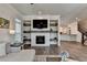 This living room features wood floors, a fireplace, a television, and easy access to the kitchen at 3003 Evanshire Ave, Duluth, GA 30096