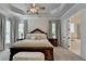 Spacious primary bedroom features a tray ceiling, neutral color palette, and ensuite bath at 3003 Evanshire Ave, Duluth, GA 30096