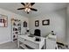 Bright home office featuring great natural light, modern ceiling fan, desk, and bookcase at 3003 Evanshire Ave, Duluth, GA 30096