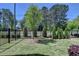 Landscaped yard featuring lush green grass and tree-lined perimeter at 3003 Evanshire Ave, Duluth, GA 30096