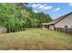 Large, fenced backyard features a well-maintained lawn, trees, and a screened-in porch at 3215 Trowbridge Dr, Cumming, GA 30040