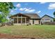 Spacious backyard features a screened-in porch, lush lawn, and a fenced perimeter at 3215 Trowbridge Dr, Cumming, GA 30040