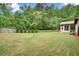 Expansive, well-maintained backyard boasts a lush lawn, mature trees, and fenced perimeter at 3215 Trowbridge Dr, Cumming, GA 30040