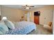 Cozy bedroom with blue bedding, a ceiling fan, adjacent bath and a chest of drawers with television at 3215 Trowbridge Dr, Cumming, GA 30040