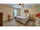 Comfortable bedroom with carpet flooring, neutral walls, ceiling fan, and a window for natural light at 3215 Trowbridge Dr, Cumming, GA 30040