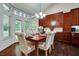 Dining area with hardwood floors, custom cabinetry, and views of the backyard at 3215 Trowbridge Dr, Cumming, GA 30040