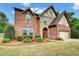 Charming two-story brick home with stone accents and a well-manicured front yard at 3215 Trowbridge Dr, Cumming, GA 30040