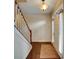 Inviting foyer with hardwood floors, staircase, and natural light streaming through the door at 3215 Trowbridge Dr, Cumming, GA 30040