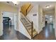 Hallway view showing office, staircase, and formal living area with fireplace at 3215 Trowbridge Dr, Cumming, GA 30040