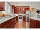 Gourmet kitchen featuring granite countertops, stainless steel appliances, and custom cabinetry at 3215 Trowbridge Dr, Cumming, GA 30040