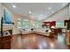 Open concept living room with hardwood floors, fireplace, and a seamless flow to the kitchen at 3215 Trowbridge Dr, Cumming, GA 30040