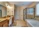 Bright main bathroom featuring a walk-in shower, soaking tub, double vanity, and natural light at 3215 Trowbridge Dr, Cumming, GA 30040