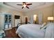 Spacious main bedroom with tray ceiling, hardwood floors, ensuite bathroom, and ample closet space at 3215 Trowbridge Dr, Cumming, GA 30040
