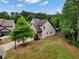 Side exterior view of a two-story home and lush green lawn at 3215 Trowbridge Dr, Cumming, GA 30040