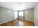 Bedroom with hardwood flooring, white closet doors, and a window with curtains at 4350 Bonaparte Dr, Tucker, GA 30084