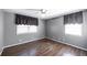 Bedroom featuring hardwood flooring, two windows, and gray painted walls at 4350 Bonaparte Dr, Tucker, GA 30084