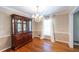 Formal dining room with hardwood floors, chandelier, and window providing natural light at 4350 Bonaparte Dr, Tucker, GA 30084