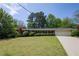 Well-manicured lawn and lush landscaping surround this one-story brick home, with an attached two-car garage at 4350 Bonaparte Dr, Tucker, GA 30084